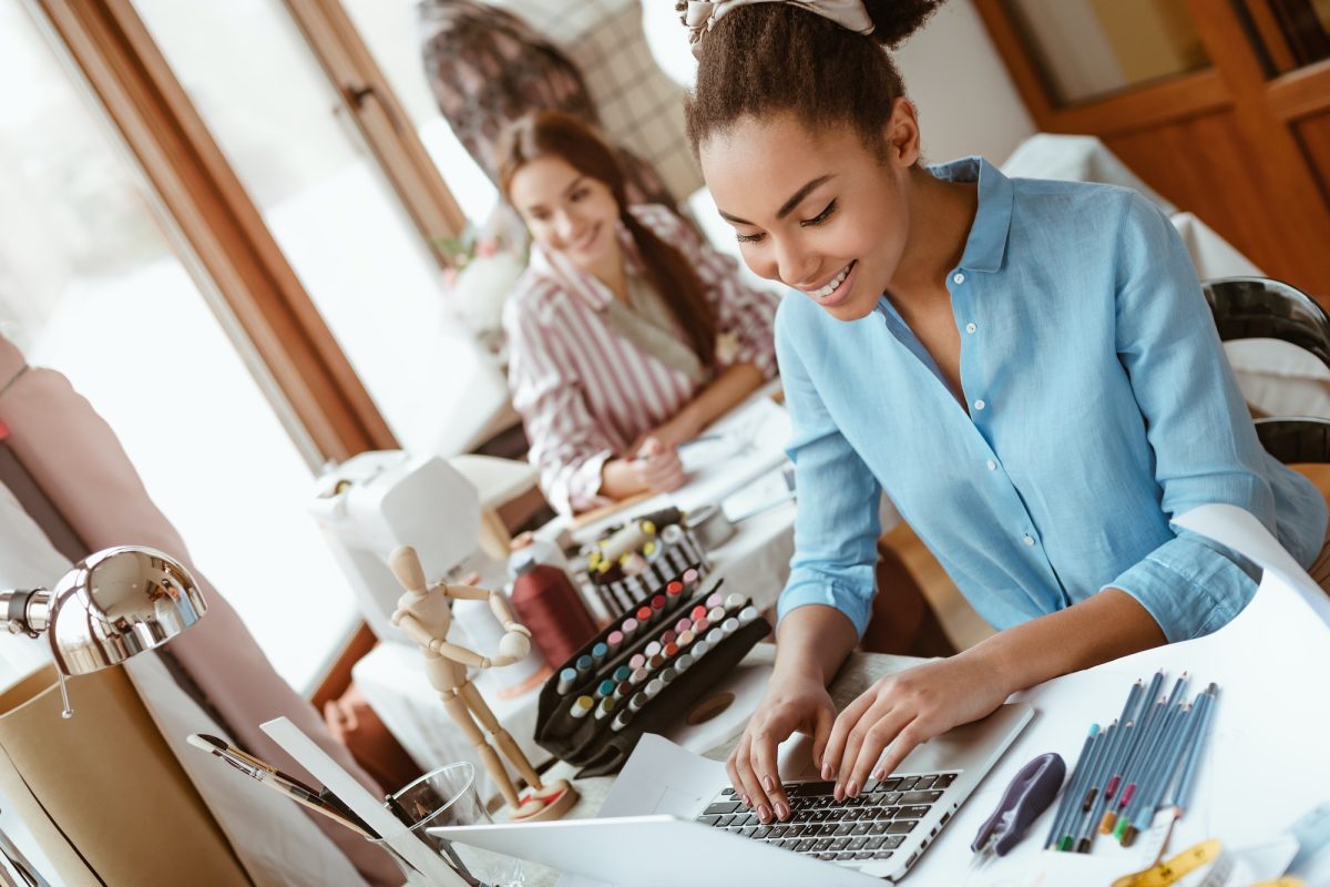Close-up of stylist coworking in design studio. Creating new design project